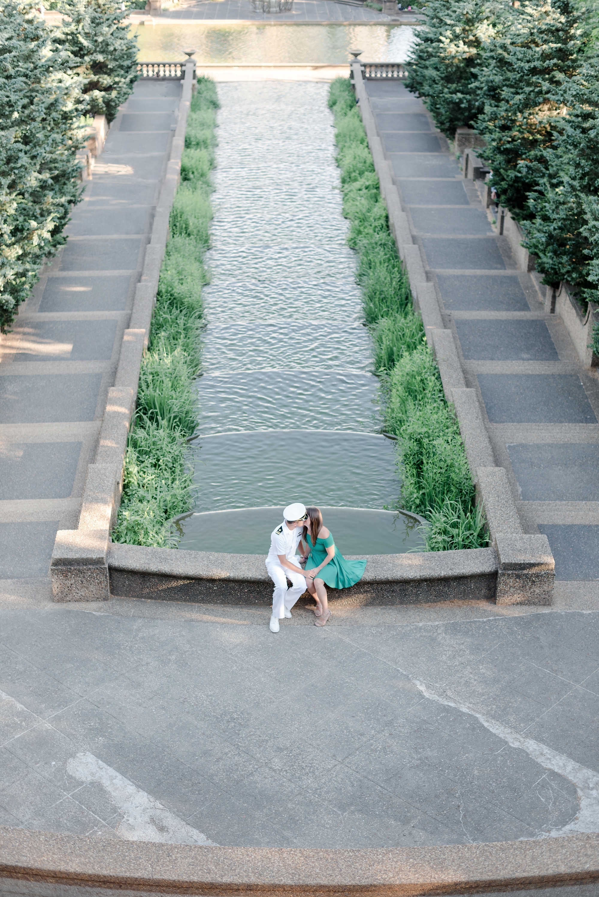 Couple sitting and kissing at fountain at Meridian Hill Park