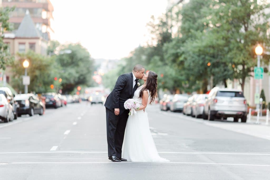 Husband and wife kissing in middle of DC street