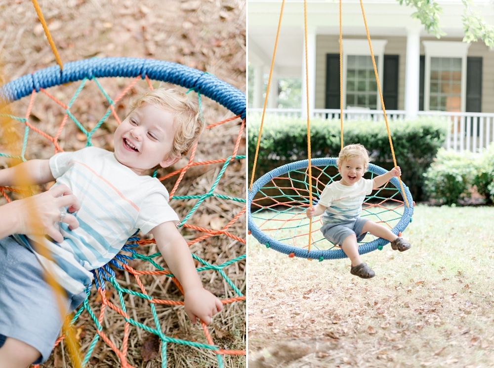 Little boy swinging and playing at home during family session photos