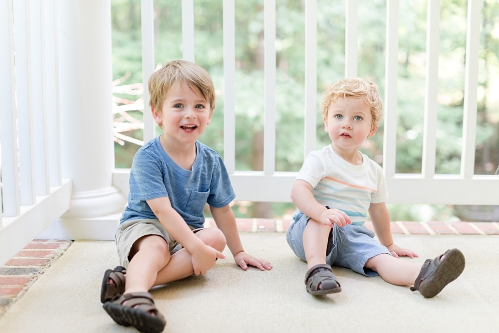 Boys smiling at camera during family photo session