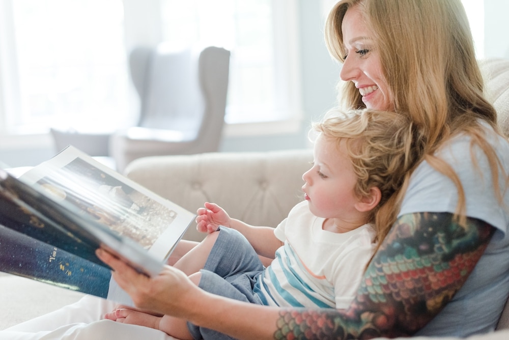 Mom and her son reading a book together at home
