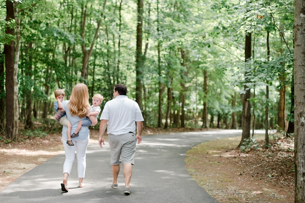 Family walking together down driveway to home