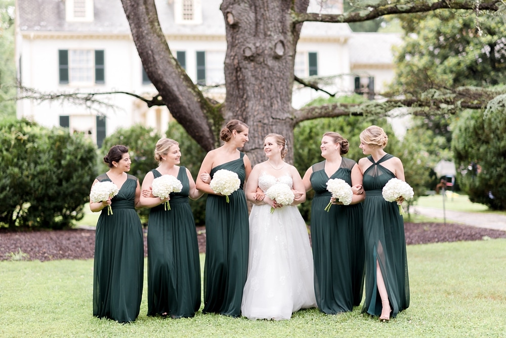 Bride and bridesmaids on grounds of Rust Manor House in Leesburg VA wedding