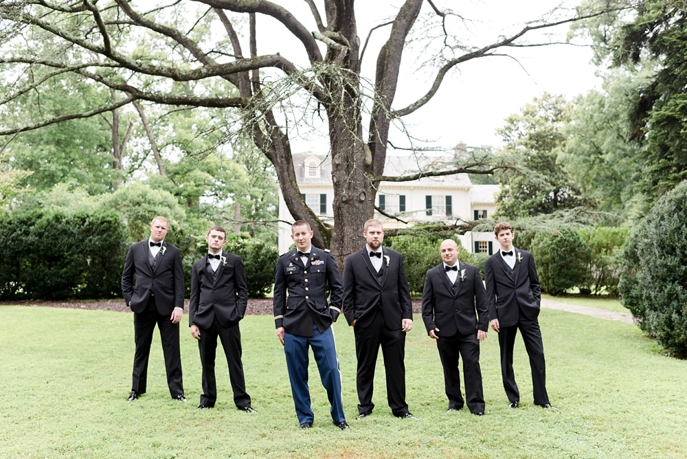 Groom and groomsmen standing on grounds of Rust Manor House wedding