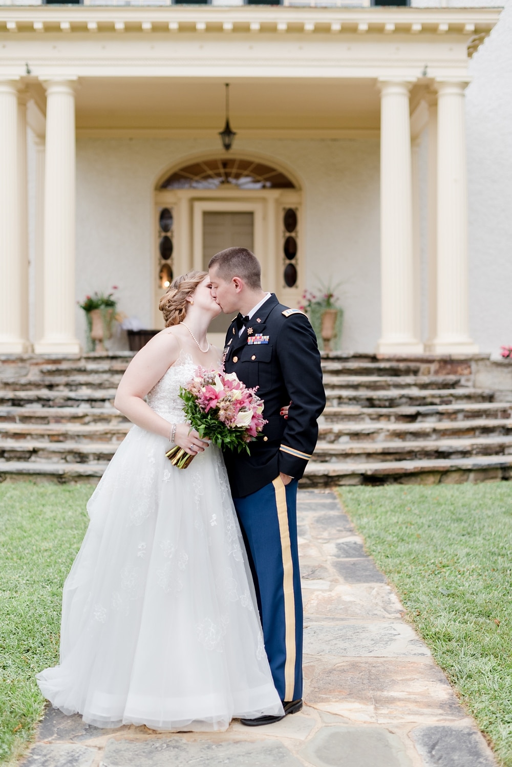 Bride and groom kissing on grounds of Rust Manor House in Leesburg VA