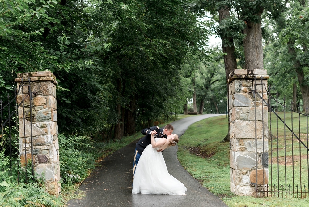 Bride and groom dipping by gate at Rust Manor House wedding in Leesburg VA