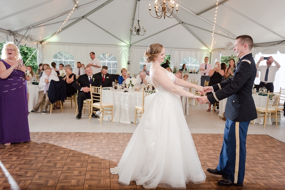 Bride and groom after first dance under tent during reception at Rust Manor House