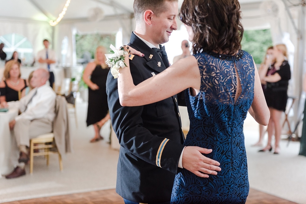 Groom mother son dance under tent during reception at Rust Manor House