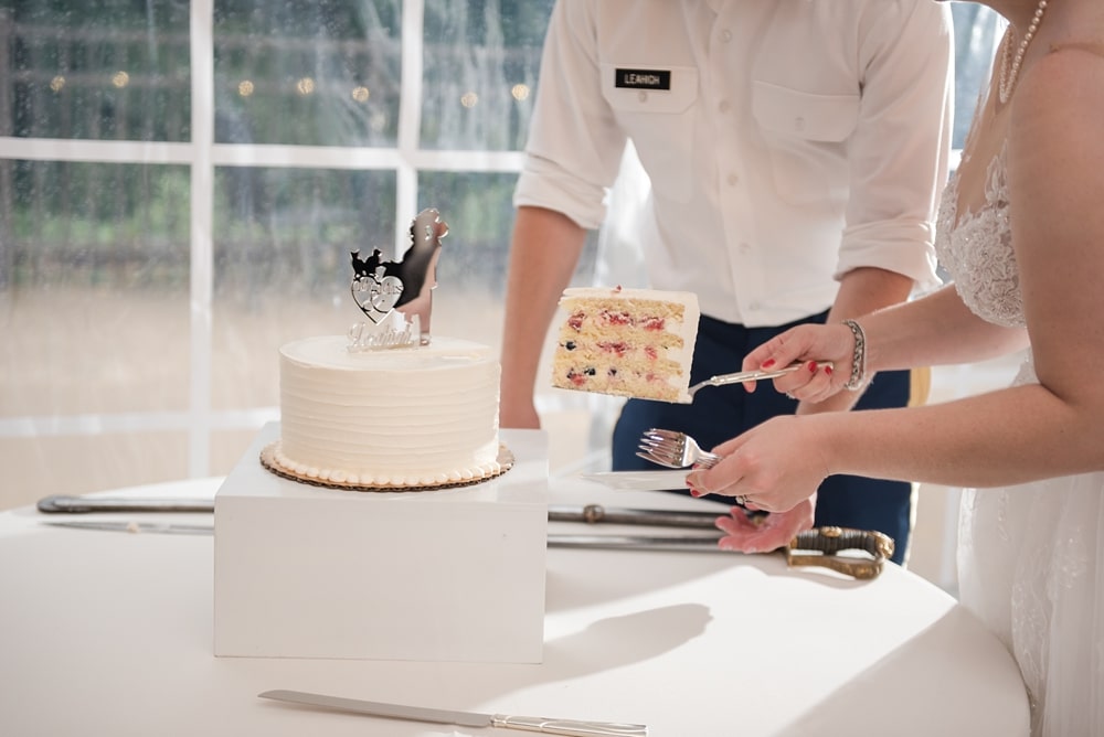 Bride and groom cake cutting by Layered Cake Patisserie LLC in VA