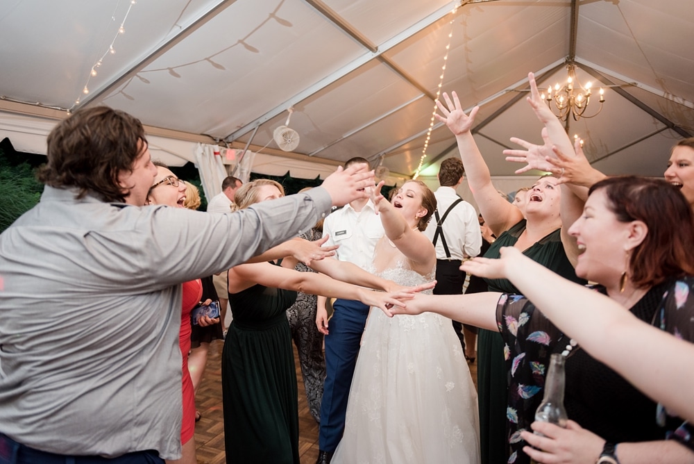 Guests dancing and singing to Sweet Caroline at wedding reception at Rust Manor House