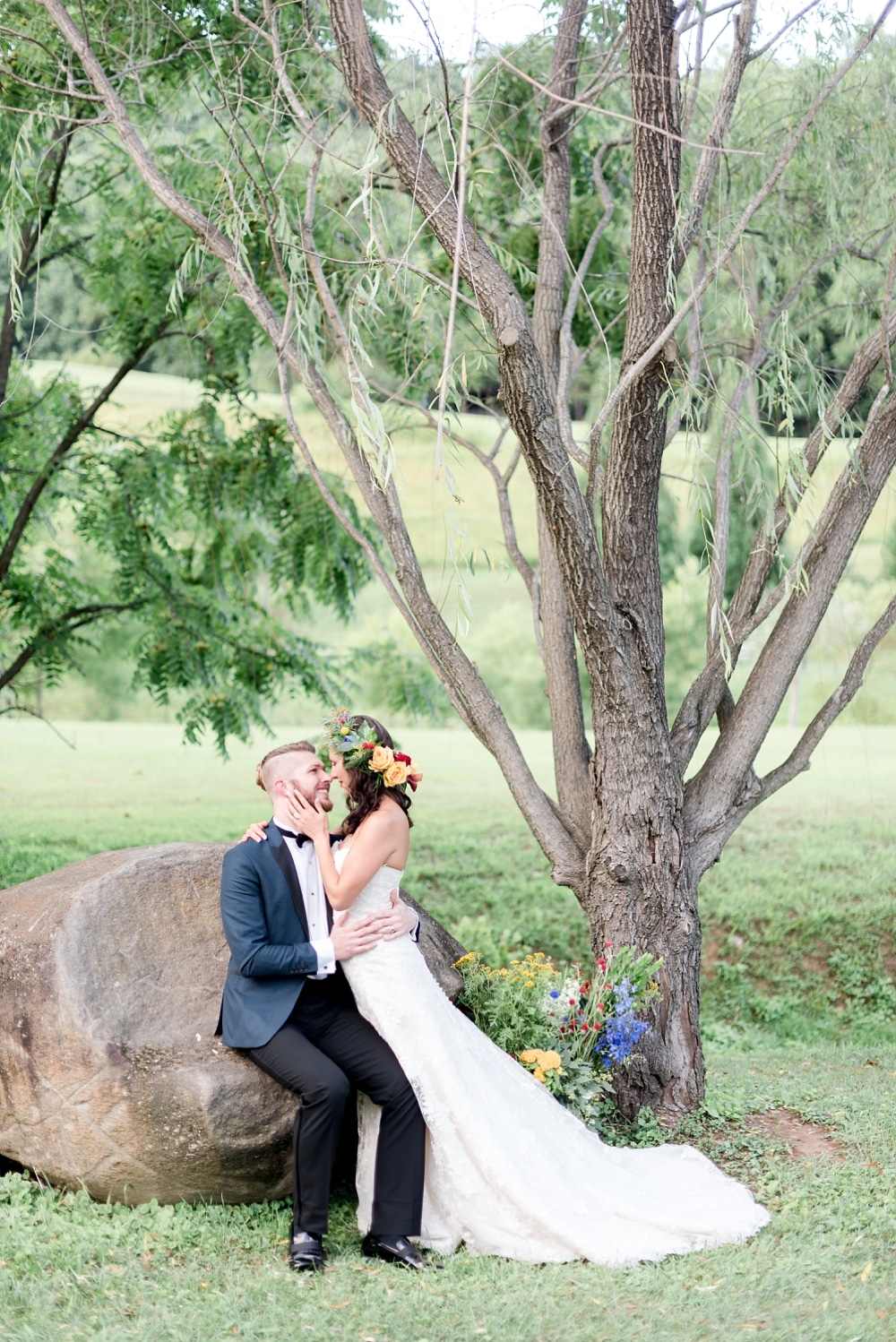 Bride and groom by weeping willow tree at DelFosse Winery in VA
