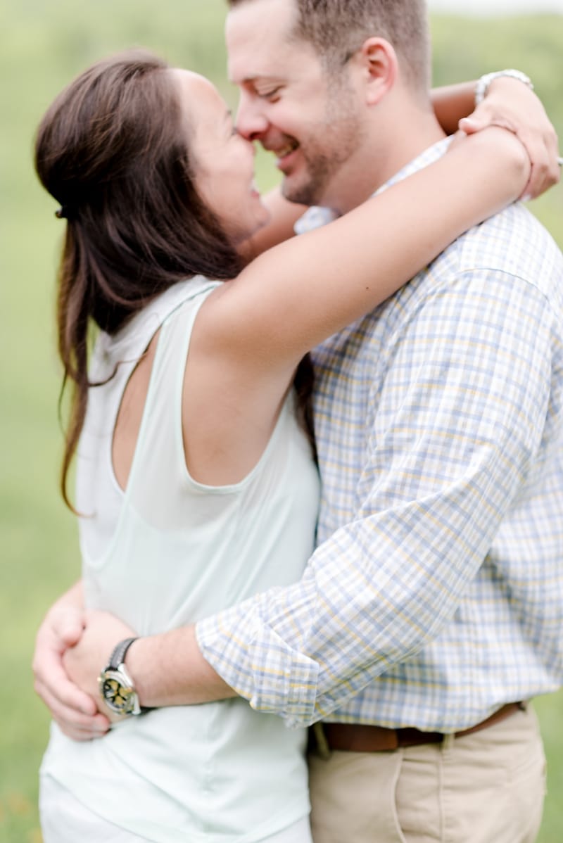 Couple kissing during engagement photos in Loudoun County winery and vineyard