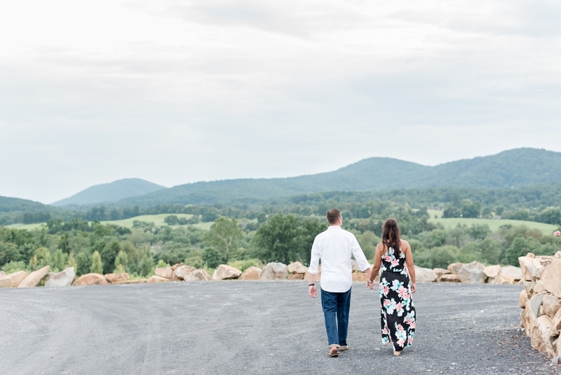 Couple walking with mountains in distance at Blue Valley VIneyard