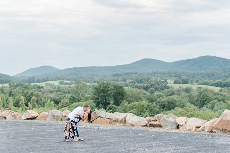 Couple sitting over view at Blue Valley Vineyard engagement photo session