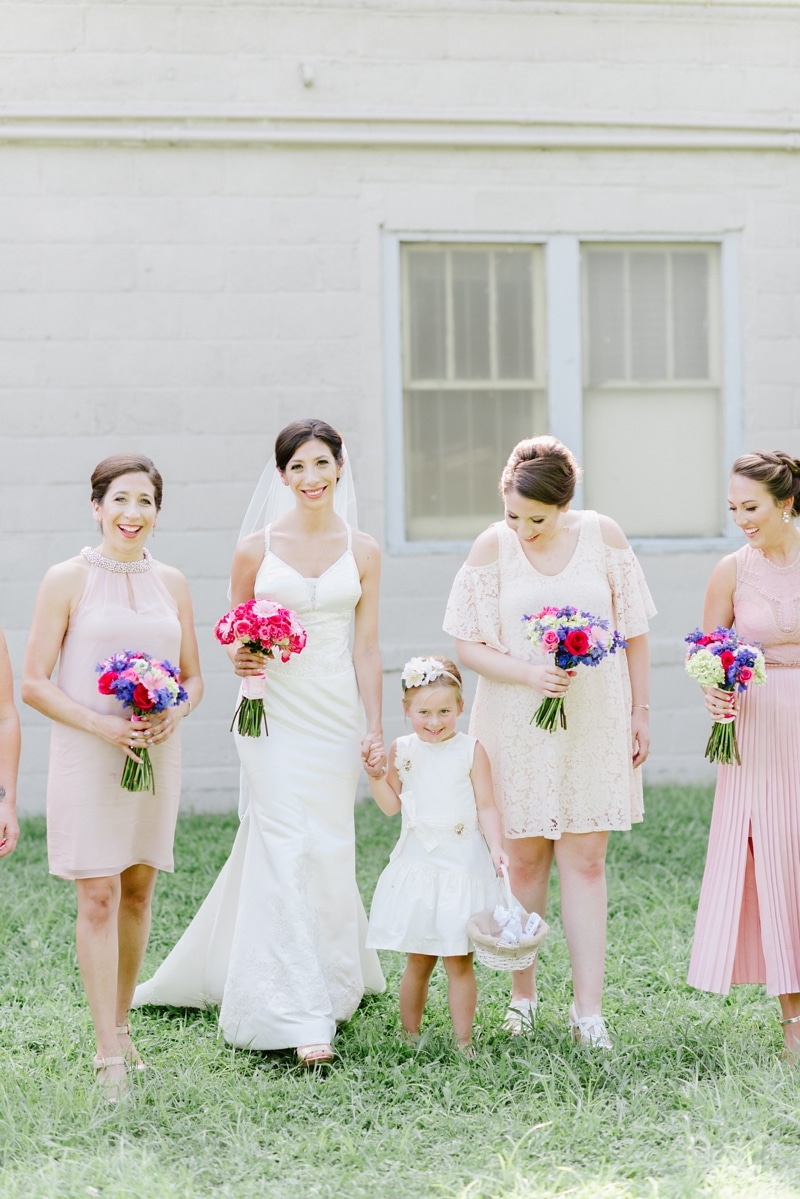 Bride and her ladies walking and laughing during summer wedding
