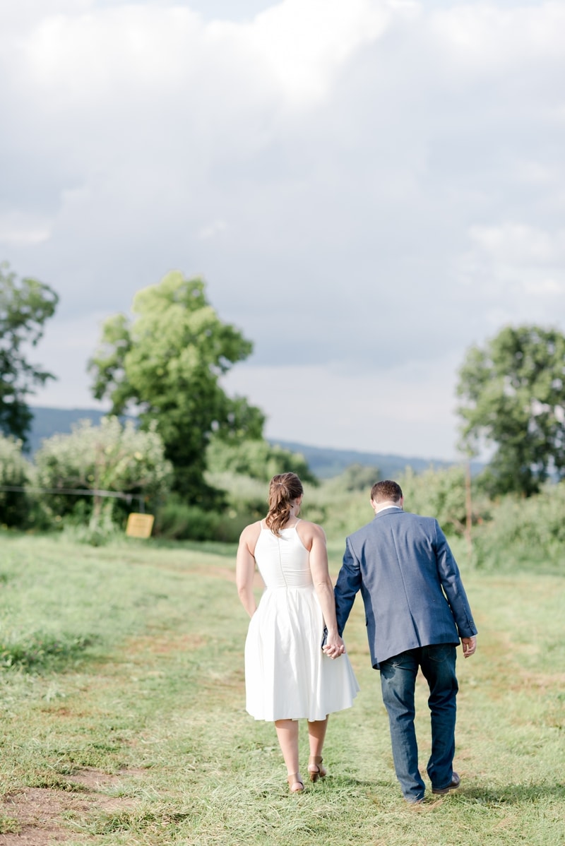 Couple walking at Bluemont Vineyard engagement session by Wolcrest Photography
