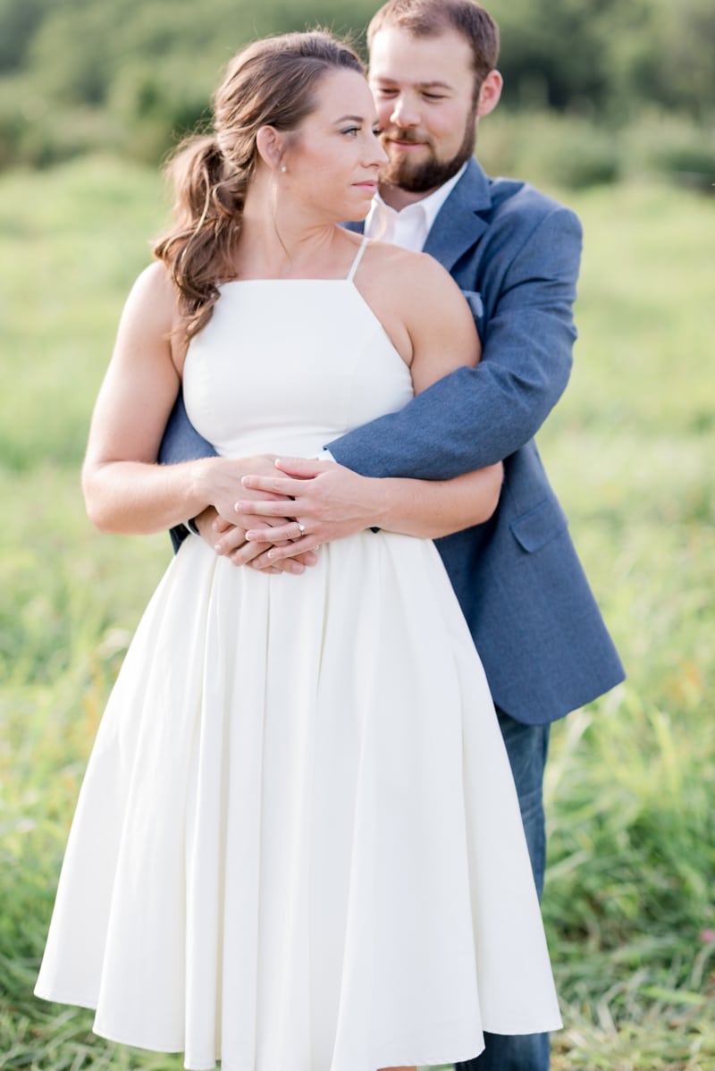 Engaged couple in field at Bluemont Vineyard VA