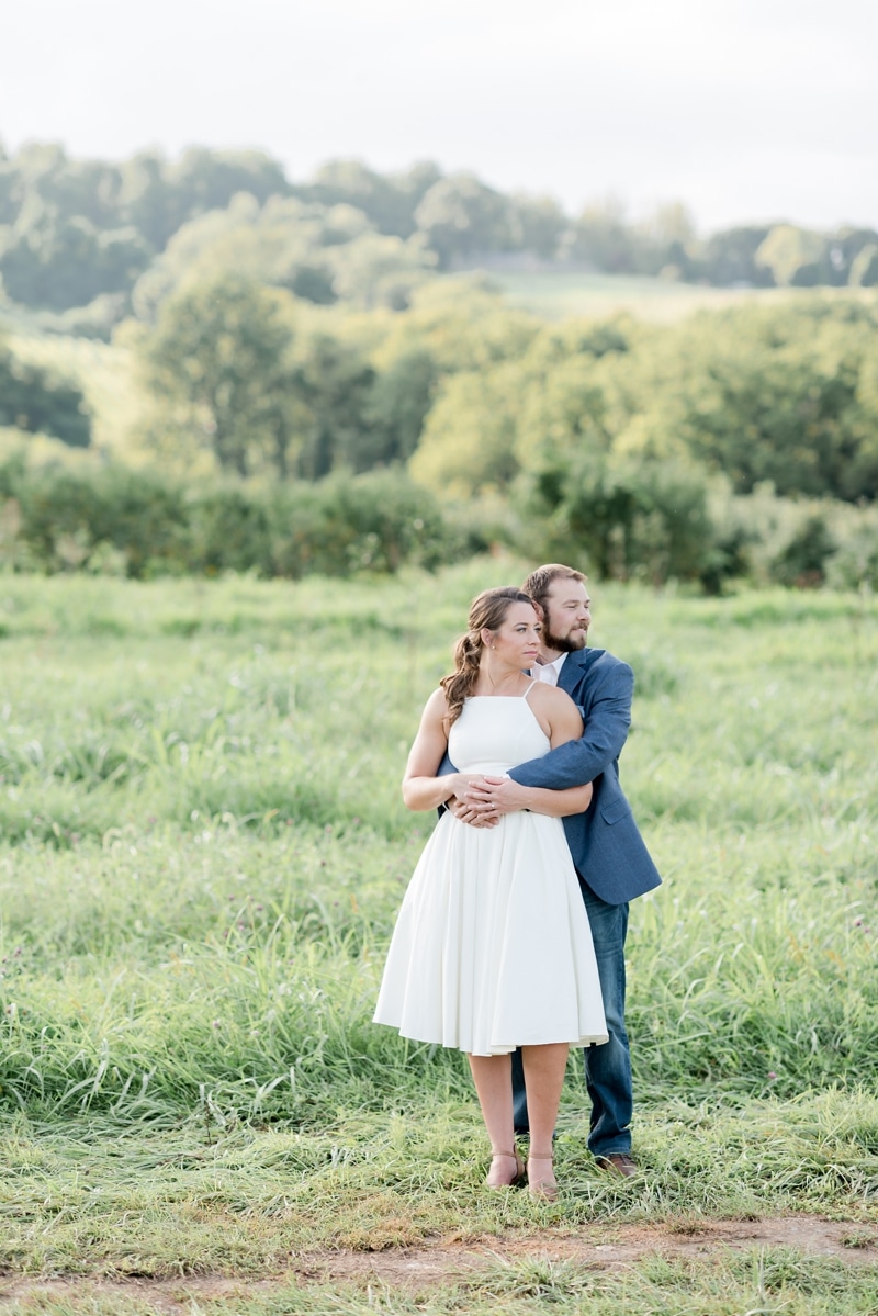 Engagement photos in field at Bluemont Vineyard in Virginia