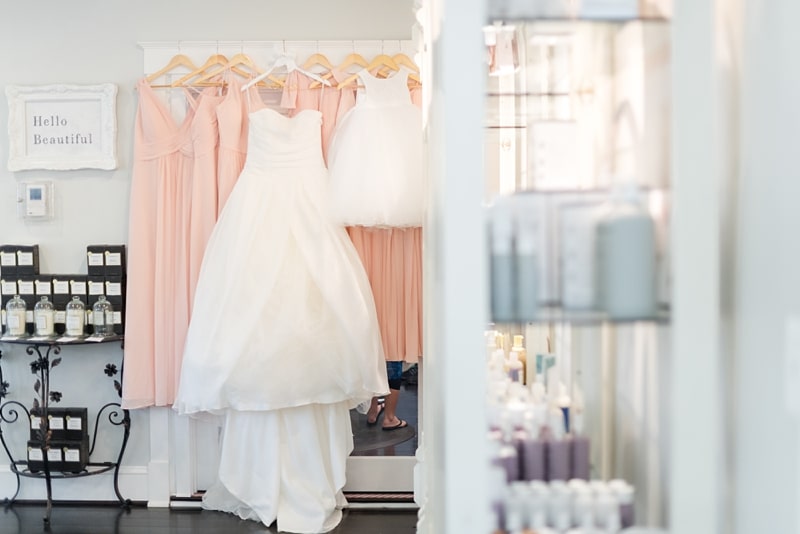 Wedding gown and bridesmaids dresses hanging at salon in Virginia