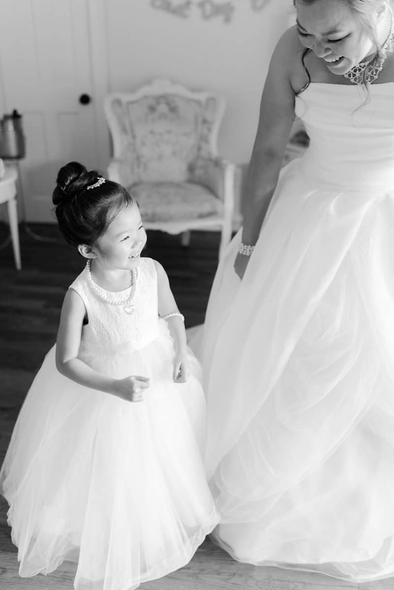 Flower girl and bride while getting ready for bluemont vineyards wedding