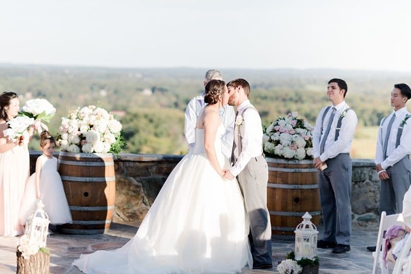 First kiss during wedding ceremony at Bluemont Vineyards