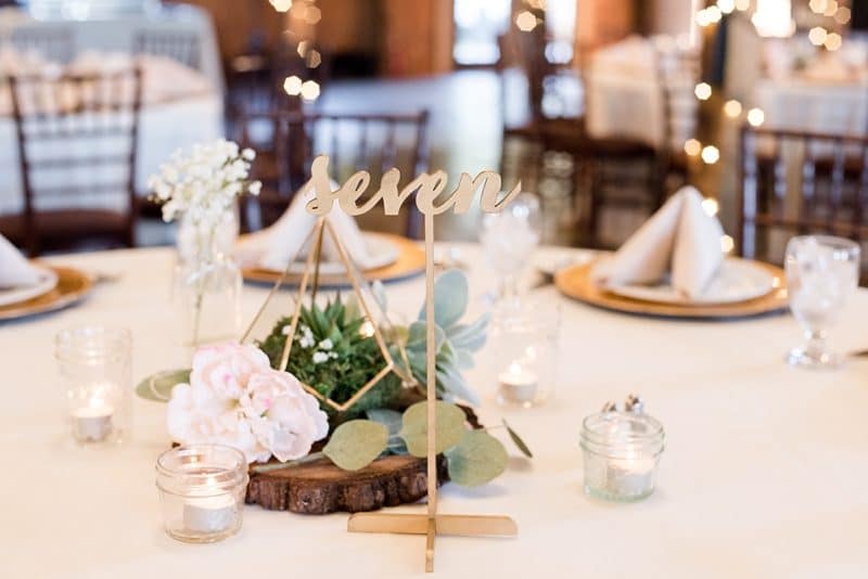 Moss and succulent centerpiece photo at barn wedding