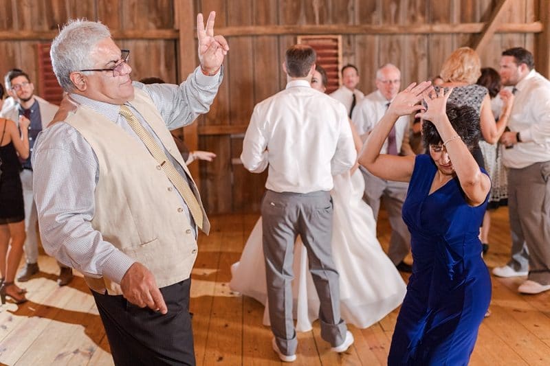 Guests dancing at barn wedding