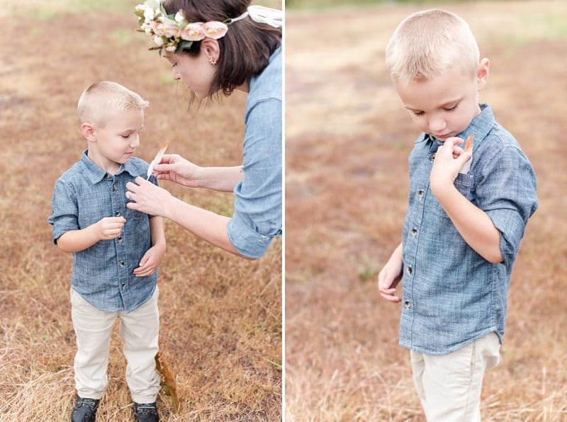 Boy putting a feather in his pocket during photo session