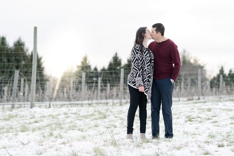 couple kissing during engagement session at The Barns at Hamilton Station